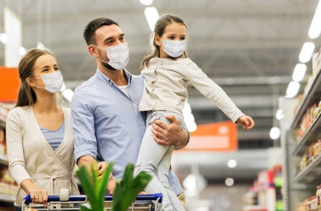 Family shops for groceries with masks on during the pandemic
