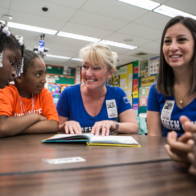 April Lewis reading to school children