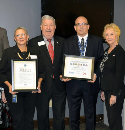 People holding up awards from the Veteran event