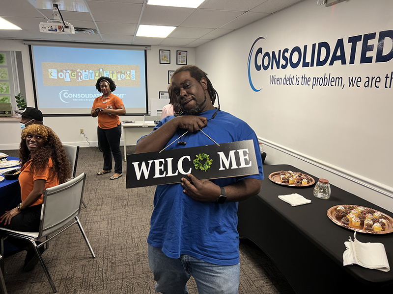 Man holding up Welcome sign