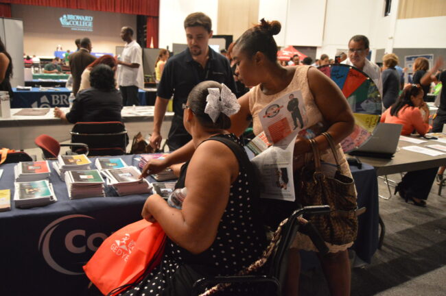 Woman receiving pamphlets at the Naturalization Seminar